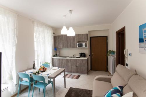 a living room with a couch and a table at AcquaTerraFuoco - City apartments in Como