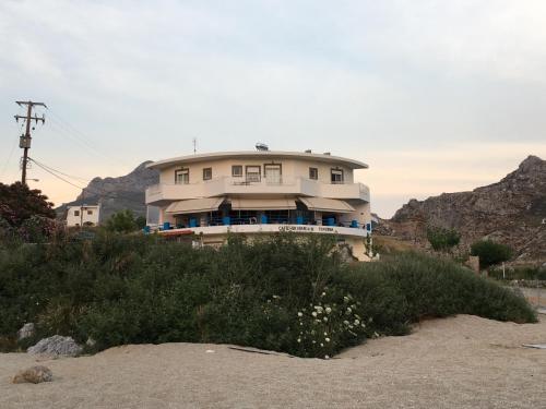 a house sitting on top of a beach at Schoinaria Bay in Damnoni