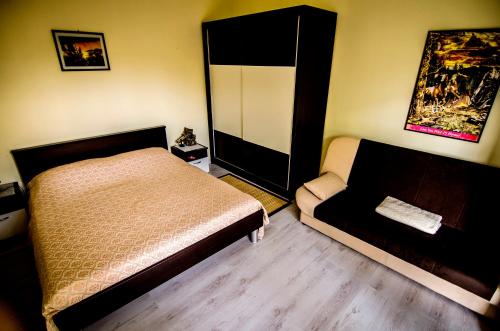 a bedroom with a bed and a chair in it at Apartman Darja in Umag