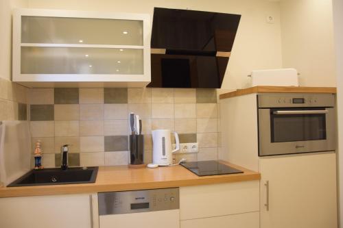 a small kitchen with a sink and a microwave at Ferienwohnung Smutje in Kiel