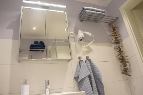 baño con espejo y lavabo en Ferienwohnung Smutje, en Kiel