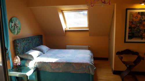 a bedroom with a bed and a window and a chair at Peahen Residence in Sigulda