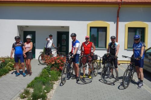 a group of people standing with their bikes in front of a building at Lednicko-valtický apartmán in Hlohovec