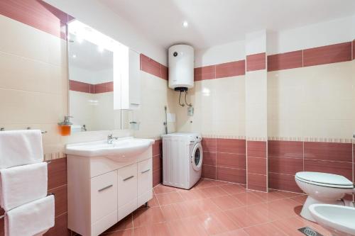 a bathroom with a sink and a washing machine at Apartment Eli Kacjak in Dramalj