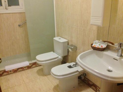 a bathroom with a toilet and a sink at Playa de Palma Beach House in Playa de Palma