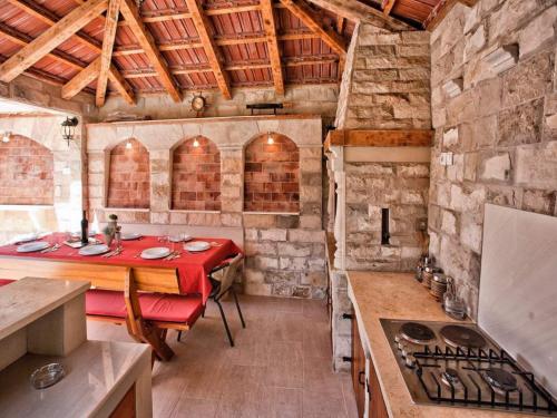a kitchen with a table and a stove in it at Apartments Radonjić in Kotor