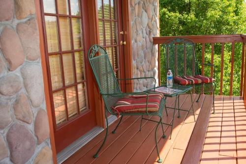 a green chair sitting on a porch next to a window at Berry Springs Lodge in Sevierville