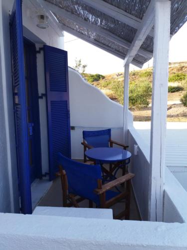 two blue tables and chairs on the porch of a house at Kapetan Giannis in Adamas