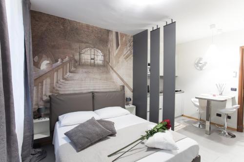 a bedroom with a bed with a wall with a staircase at AcquaTerraFuoco - City apartments in Como