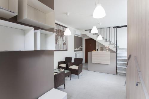 a living room with chairs and a table and a staircase at AcquaTerraFuoco - City apartments in Como