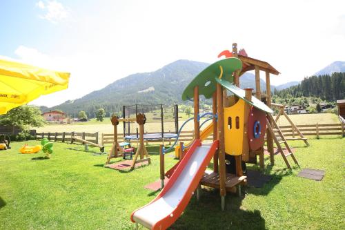a playground with a slide in the grass at Loipenstubn in Brixen im Thale