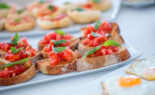 a plate of toast with tomatoes on it at Hotel Onda Verde in Praiano