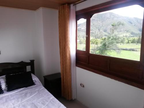 Postel nebo postele na pokoji v ubytování Hospedaje El Mirador