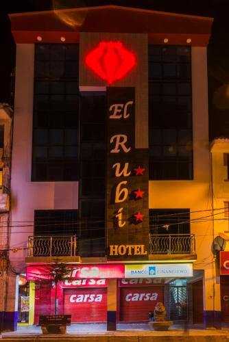 a hotel with a sign on the side of a building at Hotel El Rubi in Huaraz