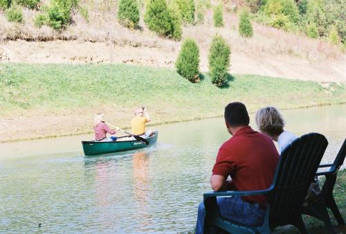 a group of people in a boat on a river at Berry Springs Lodge in Sevierville