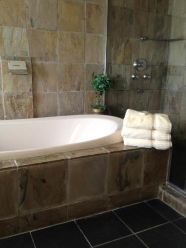 a bathroom with a bath tub with towels on it at The Belvedere Inn & Restaurant in Saugatuck