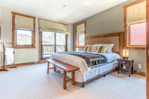 a bedroom with a large bed and windows at Yukimi # 1 in Kutchan