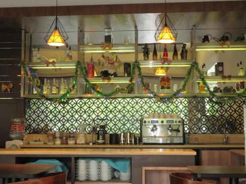 a kitchen with a counter with christmas decorations on the wall at Sweet Garden Guest House in Malang