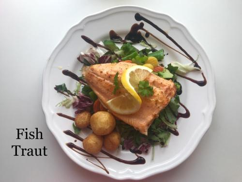 a plate of food with fish and a salad at Guesthouse Kiljan in Blönduós