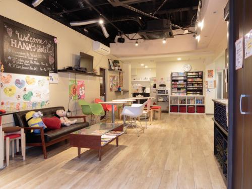 a store with a couch and chairs and a table at Fukuoka Hana Hostel in Fukuoka
