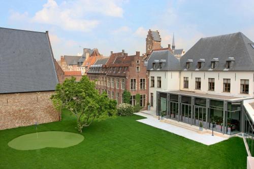 an aerial view of a building with a green yard at Martin's Klooster in Leuven