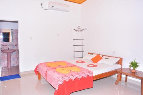 a bedroom with a bed in a room at Pleasant Park Holiday Inn in Trincomalee