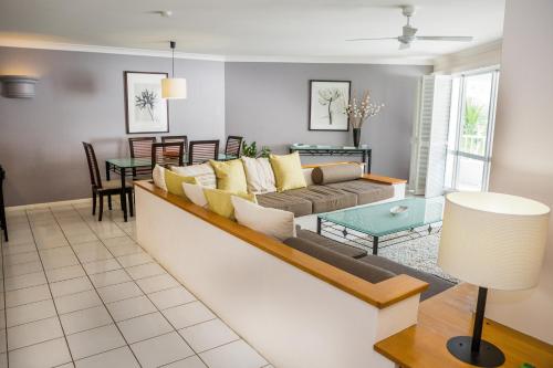 a living room with a couch and a table at Alamanda - Suite 46 in Palm Cove