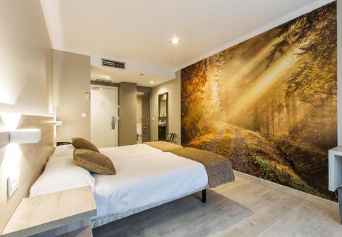 a bedroom with a large painting on the wall at Hotel Alda San Carlos in Santiago de Compostela