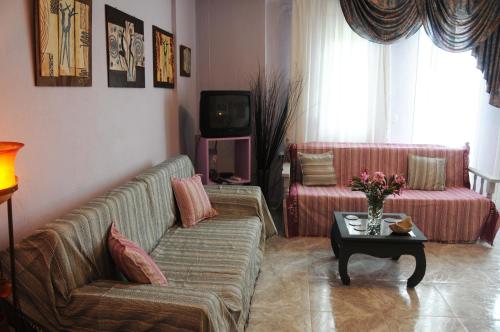a living room with a couch and a table at House of Arts in Pélla