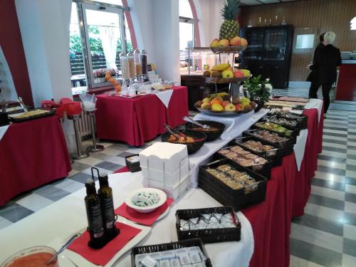 a buffet of food on tables in a room at Hotel Spa Pinar del Mar in Platja  d'Aro