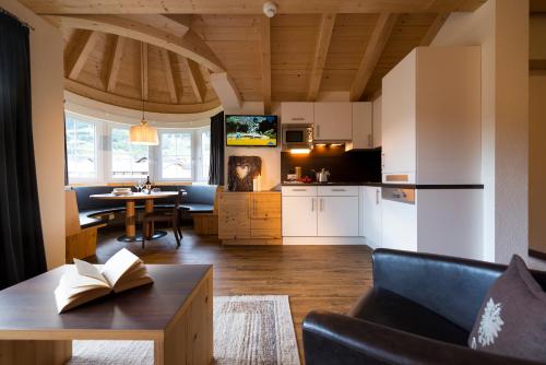 a kitchen and living room with a couch and a table at Romantica Schlössl in Fiss