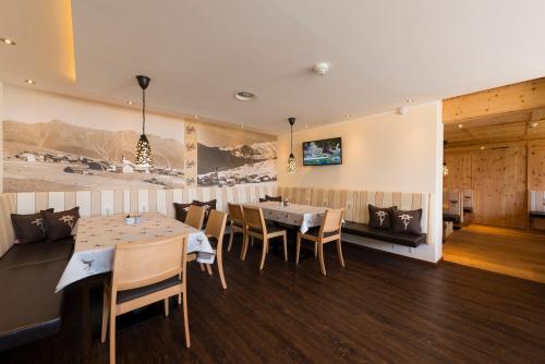 a dining room with a table and chairs at Romantica Schlössl in Fiss
