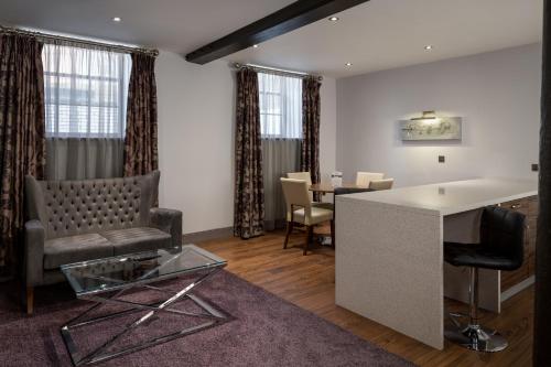 a living room with a couch and a table at Roomzzz Newcastle City in Newcastle upon Tyne