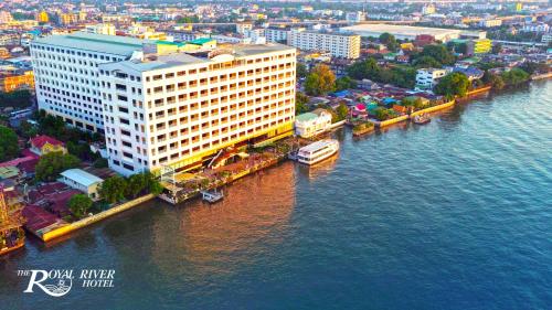 an aerial view of a large building next to the water at The Royal River Hotel in Bangkok