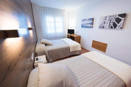 מיטה או מיטות בחדר ב-Hotel Nadal