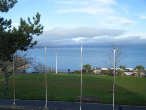 a park with a view of the ocean at Babbacombe Royal Hotel and Carvery in Torquay
