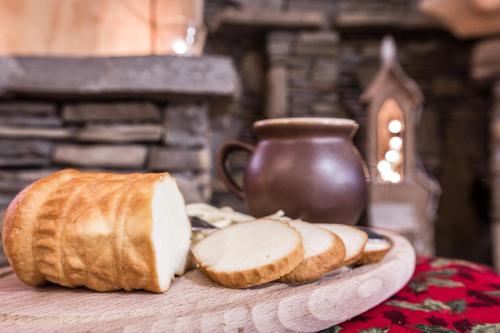 a table with a plate of bread and a jug at Willa Baciarka-basen, sauny i jacuzzi in Kościelisko