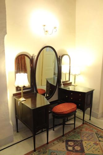a dressing room with a vanity and a mirror at Brijraj Bhawan Palace Hotel in Kota
