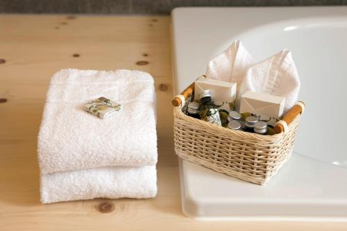 a basket sitting on a table next to a towel at Romantik Hotel Muottas Muragl in Samedan