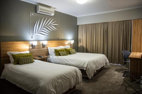 Ένα ή περισσότερα κρεβάτια σε δωμάτιο στο Palm Lodge Guest House