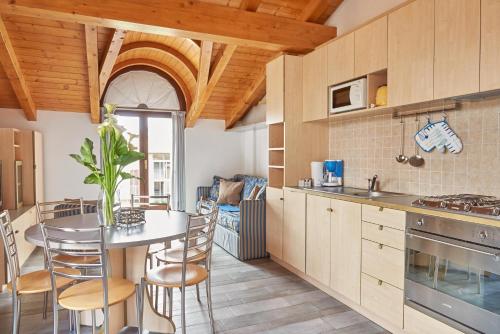 a kitchen with a table and chairs in a room at Residence Domaso in Domaso
