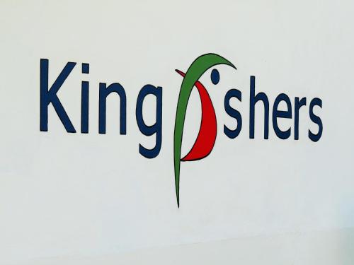 a company logo on a wall at Kingfishers Apartments in Bijilo