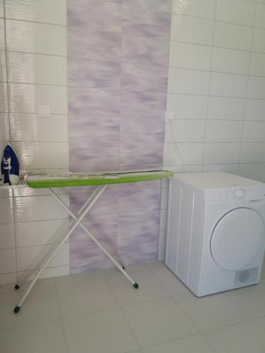 a laundry room with a washing machine and a counter at Lavanda Mobile Homes & Villas in Orebić
