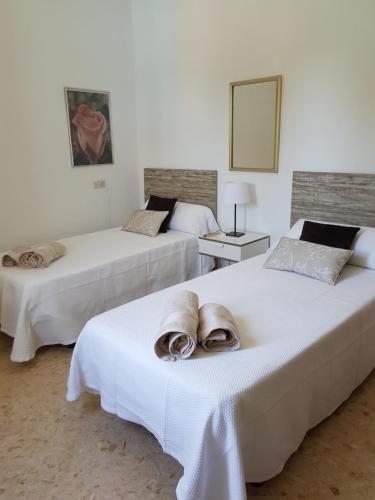 two beds with towels on them in a room at Son Roqueta in Palma de Mallorca
