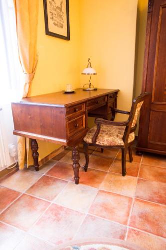 a desk and a chair with a lamp on top of it at Pension PREMIUM in Český Krumlov