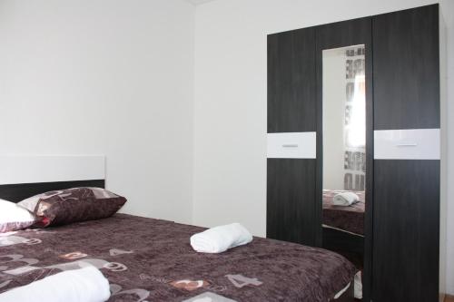 a bedroom with a bed and a mirror at Apartment Stipe in Maslenica