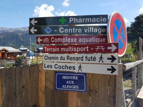 a street sign with many different signs on it at Luxury Apartment MONTCHAVIN in Montchavin