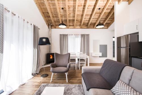 a living room with a couch and a chair at Casas do Caminho Novo in São Roque do Pico