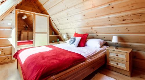 a bedroom with a bed in a log cabin at Rent like home - Tetmajera in Zakopane