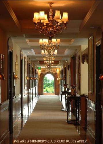 a hallway in a building with a chandelier at The Palms Town & Country Club - Resort in Gurgaon